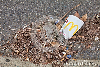 McDonalds empty cup and litter left by the side of the road Editorial Stock Photo